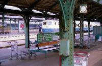 View across the platforms at Kassel Hauptbanhof in June 1990 from a departing train en-route to Wurzburg. In an adjacent platform a DB Class 141 electric waits with another service while the coaches in the background are in the then recently applied Inter-Regio livery. <br><br>[John McIntyre /06/1990]