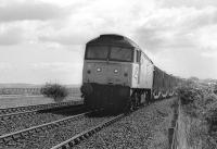 47152 climbs away from Drumshoreland with a car train for Bathgate on 23 May 1990. In the background is the Almond Viaduct on the E & G main line.<br><br>[Bill Roberton 23/05/1990]