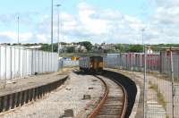 A grubby Northern Sprinter, 150224, arrives at Heysham Port with the daily boat train that connects with the Isle of Man sailing. [See image 39282] for a 1987 view of the same location. Since that time the station has been rationalised but lorry traffic through the port has greatly increased and the security fencing has consequently expanded. <br><br>[Mark Bartlett 19/06/2012]