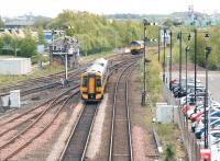 A Dunblane - Edinburgh service leaves Stirling for the south on 9 May 2012. The 158 is about to pass a Colas Rail class 66 standing in the sidings just beyond Stirling Middle signal box.<br><br>[John Furnevel 09/05/2012]