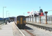 Northern Sprinter 150224 arrives at Heysham Port to connect with the IOMSP MV <I>'Ben My Chree'</I> seen here newly arrived from Douglas. [See image 34887] for the same location in 1987, since when the track has been rationalised and the roof and side panels removed revealing the ships in the harbour alongside.<br><br>[Mark Bartlett 19/06/2012]