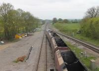 66004 has just passed through the closed station of Brocklesby <I>wrong line</I> with a train from Immingham and is now crossing to the west bound line to travel towards the junction at Barnetby. For some reason the front half of the train was empty but the rear was loaded with coal. <br><br>[Mark Bartlett 21/05/2012]