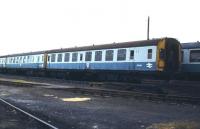 Withdrawn class 126 stock, with SC79164 nearest the camera, languishing in the sidings at Ely Dock Junction in February 1983. The units are awaiting removal for scrapping at the nearby plant of European Metal Recycling, Snailwell, Cambridgeshire. Note the 'danger' stickers attached to the sides of the stock, warning of the asbestos contained within these units. Snailwell was one of a small number of specialist sites equipped to deal safely with such material. [See image 31786]<br><br>[Ian Dinmore 12/02/1983]