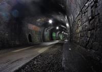 Inside Cressbrook Tunnel looking east on 17 June 2012 showing the lighting and the cycle/footpath. The tunnel is 471 yards long and on the right a 10' thick concrete slab runs the length of the tunnel and is believed to contain a water main.<br><br>[John McIntyre 17/06/2012]