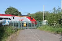 A <I>Pendolino</I> on a Manchester to Euston service passes the site of Hixon Halt (closed 1947) and its infamous level crossing. In 1968 a Euston bound express hauled by AL1 E3009 smashed into a 120 ton transformer on a low loader on the automatic half barrier crossing and eleven people were killed. The subsequent public enquiry resulted in a number of recommendations to improve safety at these crossings.  A bridge was eventually built at Hixon in 2002 but it is still available as an engineers' access point.<br><br>[Mark Bartlett 25/05/2012]