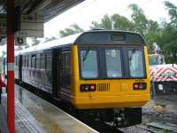 142001 stands at the platform at Wigan North Western station on a wet 22 June 2012.<br><br>[Veronica Clibbery 22/06/2012]