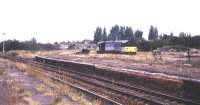 View across crumbling and overgrown platforms at March station in 1993. In the background a class 58 ambles past on its way to Whitemoor Yard. <br><br>[Ian Dinmore //1993]