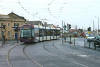 A grey wet day at Cleveleys on 16 June as 010 leaves the town centre heading for Blackpool and 011 comes off the central reservation section heading for Fleetwood. The weather was however merely a foretaste of the dreadful conditions that would be experienced here less than a week later when the Olympic Torch arrived at Cleveleys from Rossall on a vintage tram [See image 39323]<br><br>[Mark Bartlett 16/06/2012]