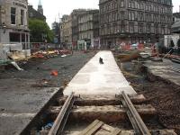 Looking towards Shandwick Place from the west end of Princes Street on 22 June 2012, showing a cast concrete base now in place running from the end of the in situ eastbound tram track.<br><br>[David Pesterfield 22/06/2012]