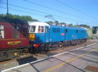 But for that yellow line, and the label on the coach, it could be 1964. Preserved 86259 <I>Les Ross</I>, in original Electric Blue, takes the Railway Touring Company 'Cumbrian Mountain Express' north and away from London at Milton Keynes on 18 June, at a time when several million commuters are heading the other way.<br><br>[Ken Strachan 14/06/2012]