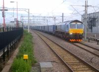 A tad colourful - 66434 in W H Malcolm livery waits for the road with an up container train at Rugby on 26 June. The usual DBS container train was loading in the sidings to the right at the same time... form an orderly queue, please!<br><br>[Ken Strachan 26/06/2012]