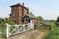 The substantial station at Woodhall Junction (named Kirkstead from opening until 1922) was on the direct line from Lincoln to Firsby and only closed in 1970. It was also the junction for lines to Boston (closed 1963) and the Horncastle branch which closed to passengers in 1954 but still saw occasional freight trains as late as 1971. View towards Boston from the site of the old level crossing, now replaced by a new road that crosses the adjacent river at a much higher level behind the camera.<br><br>[Mark Bartlett 21/05/2012]