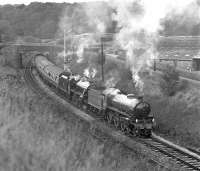 Preserved B1 No. (6)1306 and Black 5 No. 45407 crawl into Wennington station with the eastbound <I>Pennine Dalesman</I> railtour on 16th October 1976. The train was held for some minutes awaiting a preceding Morecambe - Leeds dmu service to clear the long section to Settle Junction.<br><br>[Bill Jamieson 16/10/1976]