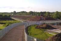 Progress on Nuneaton North Chord, 28 June 2012. The sharp eyed observer will note the absence of the Ashby line bridge over the WCML [see image 38566] in this view looking North-East. Notice also the first layer of ballast on the new embankment. You probably won't be able to see the white tape blanking out the words 'July 2012' as the finish date on the contractors' boards.<br><br>[Ken Strachan 28/06/2012]