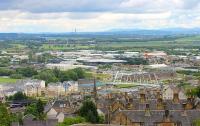 Stirling station, as seen from the castle, showing the signal box at the south end, a Class 158 stabled at the north end and the distinctive modern footbridge. In the distance Longannet Power Station can be seen on the banks of the Forth.<br><br>[Mark Bartlett 01/07/2012]