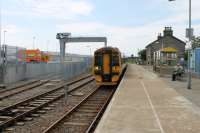 Having shuttled to Thurso and back 158702 runs in to Georgemas Junction ready to continue on to Wick. In the background the new crane and loading area for the Dounreay flasks are nearing completion and as a result the footbridge has gone and the old platform has been incorporated into the perimeter fence. [See image 12679] for the same location in 1989. A few days after this photo was taken two DRS Class 37s with a nuclear flask wagon made a timing run to Georgemas Junction ahead of the Dounreay traffic commencing in earnest.<br><br>[Mark Bartlett 06/07/2012]