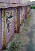 A long girder bridge crosses the line to Glasgow at Gartsherrie. In the 1990s the bridge featured this graffiti which fans of Monty Python might enjoy. The junction is off to the distant left.<br><br>[Ewan Crawford 03/05/1997]