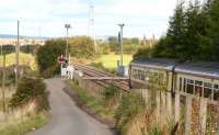 View north at Heatherbell LC between Gartsherrie S and Garnqueen N Jct on 25 Sept 2007 as a Motherwell - Cumbernauld service approaches.<br><br>[John Furnevel /09/2007]
