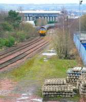 Looking south alongside the site of Grangemouth station (right) towards Fouldubs Junction in December 2011 with a train of empty oil tanks approaching. The line into Grangemouth docks ran directly below the camera and under the A904 Station Road. [See image 47486] <br><br>[John Furnevel /12/2011]