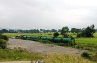 The <I>Lairg Tanks</I>, a weekly working from Grangemouth, approaches Dingwall on Friday 6th July 2012. Here 66110 and its eight four wheeled fuel tanks will wait to cross a southbound passenger service. My own train to Wick later overtook the freight at Tain station.<br><br>[Mark Bartlett 06/07/2012]