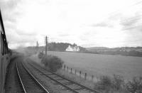 A photograph taken from a carriage window during <I>'The Borders Railtour'</I> shortly after leaving St Boswells station on 9 July 1961 on the way to Greenlaw. The locomotives at the head of the train are Ex-NBR no 256 <i>Glen Douglas</i> and J37 no 64624.<br><br>[K A Gray 09/07/1961]
