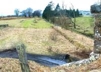 The remains of Macbie Hill station looking south west towards Dolphinton in June 1994, with platform remains on the right and the former loading facilities beyond. Originally opened by the Leadburn, Linton and Dolphinton Railway as Coalyburn in 1864, a name it carried for the first 10 years of its life, the station closed as long ago as 1933.<br><br>[John Furnevel 09/06/1994]