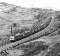 76032+76034 approaching Dunford Bridge with another MGR working from the South Yorkshire coalfield to Fiddler's Ferry power station near Runcorn in July 1981. The pair of 1500V DC Bo-Bo electrics will give way to LMR diesel power at Godley Junction.<br><br>[Bill Jamieson 17/07/1981]