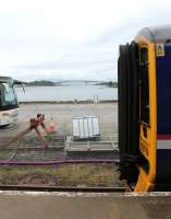 Newly arrived 158719 stands at the quayside station in Kyle of Lochalsh on 11 July 2012, with the Skye Bridge in the background. <br><br>[Mark Bartlett 11/07/2012]