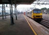 A busy evening at Nuneaton, with an up Pendolino passing platform 4 and a Freightliner giving similarly short shrift to platform 5. A 66-hauled freight had just crossed the bridge in the background, proving the value of its reinstatement. The change in the edging slabs on platform 5, along with the longitudinal line of drain gratings, shows where the Ashby bay was filled in [see image 26581].<br><br>[Ken Strachan 12/07/2012]