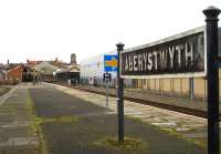 The well weathered running in board at the seldom used country end of the operational platform at Aberystwyth Station in May 2012. View towards the now multi-user former Cambrian Railways station building.<br><br>[David Pesterfield 10/05/2012]