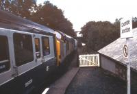 A failed DMU reaches Coombe Junction in August 1991, thanks to assistance in the rear from a class 37 hauling a train of clay hoppers from Moorswater depot. The combination continued up the bank to Liskeard. Note the viaduct carrying the GW main line in the background.<br><br>[Ian Dinmore /08/1991]