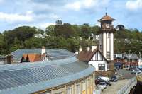 Looking over Wemyss Bay station from the 15.00 ferry departure for Rothesay on 1 June 2012. The covered walkway linking the railway station and the ferry terminal is prominent in the left foreground.<br><br>[Bill Jamieson 01/06/2012]