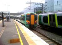 What comes down must go up. The 350 in platform 2 (left) will form a train to Euston, while its sister unit has just left from platform 1 for the same destination. Southern Trains 377203 is in platform 2a [see image 38263], and will form the 18.13 to Selhurst.<br><br>[Ken Strachan 14/06/2012]