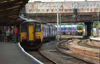 A pair of Class 150s wait on Preston's former RES platform for the next shuttle service to Ansdell & Fairhaven in connection with the Open Golf at Royal Lytham & St Annes on 21 July 2012. In the background a First TransPennine unit is leaving the station with a Manchester Airport to Blackpool North service.<br><br>[John McIntyre 21/07/2012]