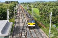 The Class 92 Test Train created a stir on the WCML during July 2012. It originally ran with four <I>stored</I> Class 92s but 92011 had returned to full service by the time this picture was taken on 18th July. 92019 approaches Hest Bank level crossing from the north with 92027 and 92025 dead in train and a rake of loaded ballast wagons. 92019 also returned to the main line the day after this run and the other two have since followed.  <br><br>[Mark Bartlett 18/07/2012]