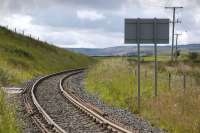 Looking west from Boig Road level crossing, New Cumnock, along the Greenburn branch, East Ayrshire, waiting for a coal train which didn't appear. Notice the bullhead rails bolted to the sleeper ends to preserve the 'geometry' of the curve - not entirely successfully in this case! [With thanks to all who responded to this query]<br><br>[Bill Roberton 19/07/2012]
