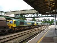 Freightliner 66560, with 66601 dead in train, waiting at signals at the south end of Hereford Station on 16 July 2012. Up ahead the 12.49 ex Birmingham New Street via Great Malvern is crossing over prior to running back into platform 3 ready for its return to Birmingham.<br><br>[David Pesterfield 16/07/2012]