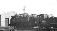 Part of the shed yard at Eastleigh in September 1963 with 'stored' steam locomotives awaiting disposal. Featured here are USA 0-6-0T no 30065, which had spent its life in Southampton Docks, from where it had been withdrawn in October 1962. Alongside is Adams B4 0-4-0T no 30089, which had ended its operational days at Guildford the previous March.<br><br>[K A Gray 25/09/1963]