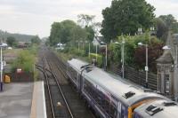 The view west from Nairn station footbridge as a pair of Class 158s leave for Inverness with an evening service from Aberdeen. The disused signalboxes survive at each end of the platform but the signaller now works from an office in the main station building. <br><br>[Mark Bartlett 03/07/2012]