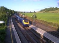 A Penzance-bound HST slows for an unscheduled stop at Castle Cary on 28 July in order to rescue passengers stranded by an earlier failure. The goods lines on the right are somewhat overgrown.<br><br>[Ken Strachan 28/07/2012]