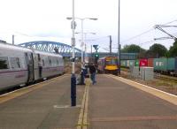 Well, that's the West side full. An East Coast train for Newcastle on platform 4, a Cross Country 170 leaving platform 5, a rusty through road, and containers for Felixstowe on the far right. A couple of spotters propping up the lamp post, and the sound of a steam whistle on the Nene Valley line in the background, completing the Tri-Power scene. All we need for 'Quad Power' is an LPG-fuelled people mover... [see image 39652].<br><br>[Ken Strachan 02/08/2012]