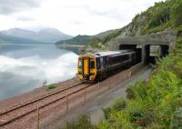 A Kyle to Inverness service heading east alongside Loch Carron in July 2012. 158715 enters the avalanche shelter at Attadale, with the station of the same name in the inlet just around the next headland.<br><br>[Mark Bartlett 11/07/2012]