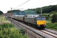 Former Royal Train locomotive 47798 <I>Prince William</I> was given to the National Railway Museum by EWS in 2004 but retained its main line status and made occasional forays from the NRM. Currently however it is in full main line use with West Coast Railways and seen here passing Woodacre on 6 August with the southbound <I>Mersey Moorlander</I>, which it had taken over at Carnforth from Black 5 45305. 47580 in <I>Stratford Jubilee</I> livery brought up the rear. <br><br>[Mark Bartlett 06/08/2012]