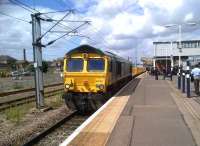 Sweating the assets: at 12 noon, 66740 was stabled outside the GBRf depot in New England yard. At 2.30, it was hauling empty bolster wagons past platform 5. At 4.30, it was stabled light engine outside the EMD depot in March (a stone building, probably the former goods shed). The blue fencing and excavators on the left are (hopefully) signs of a start on the new Western entrance to the station [see image 35318], currently framed by a gantry crane.<br><br>[Ken Strachan 02/08/2012]