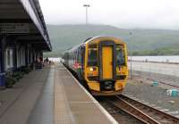 With the Isle of Skye in the background 158719 stands at Kyle of Lochalsh terminus on 11 July 2012. The prominent <I>Not to be Moved</I> sign on the front cab does not indicate a faulty set but that the train's water tanks are being replenished by station staff before it leaves as the 1203hrs departure for Inverness. <br><br>[Mark Bartlett 11/07/2012]