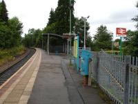 Platform view at Pentre-bach station looking towards Merthyr Tydfil on 7 August 2012. Part of the Art Deco 'Hoover' building can be seen in the right background below the station sign.<br><br>[David Pesterfield 07/08/2012]