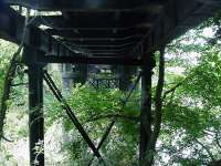 <I>Look out below!</I> The Wye Valley Railway between Kerne Bridge and Lydbrook Junction crossed the river to a tunnel through the Welsh Bicknor peninsula before crossing again to the left bank. Only the second bridge survives - as part of the Wye Valley Walk.<br>
<br>
<br><br>[John Thorn 31/05/2012]