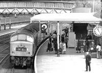 The 09.30 Glasgow Central - London St Pancras <I>'Thames - Clyde Express'</I> rolls into Dumfries in May 1971, behind the usual 'Peak' locomotive working back to Leeds. Note the time on the station clock. Despite the 'Express' tag, the train had a scheduled end to end journey time of 8 hours 50 minutes in the 1960s and early 1970s.<br><br>[John Furnevel 05/05/1971]