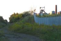 Looking north during the evening of 14 August with the Waverley route on the left and the headgear of the Lady Victoria pit glinting in the evening sun.  The Lady Victoria Colliery signal box formerly stood on the left hand side of the cutting close to here [see image 6108].<br><br>[Mark Poustie 14/08/2012]