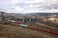 This spring 1968 shot shows just how extensive Inverness carriage sidings then were. A train from the south pulls into the station, passing a train from the north which will in a few minutes propel back into the southbound platforms. On the right is a green-liveried DMU and two wooden 'BD' containers standing at the biscuit warehouse siding.<br><br>[Frank Spaven Collection (Courtesy David Spaven) //1968]